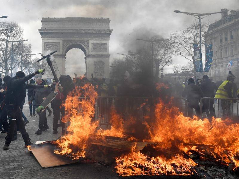 Yellow vest protesters in Paris have looted stores and set fire to buildings on the Champs Elysees.