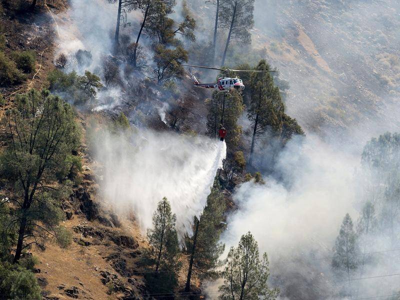 Fire crews work to battle a wildfire in Yosemite National Park that's killed one firefighter.