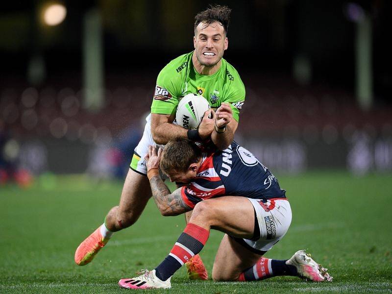 Michael Oldfield is tackled by Jake Friend as the Raiders beat the Roosters in the NRL.