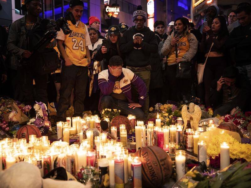 Fans have placed flowers, candles and memorabilia during a vigil for late Lakers guard Kobe Bryant.