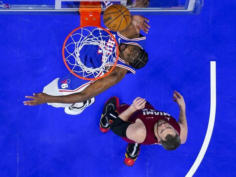 Philadelphia 76ers' Joel Embiid (left) shoots over Miami's Kevin Love in their NBA thriller. (AP PHOTO)