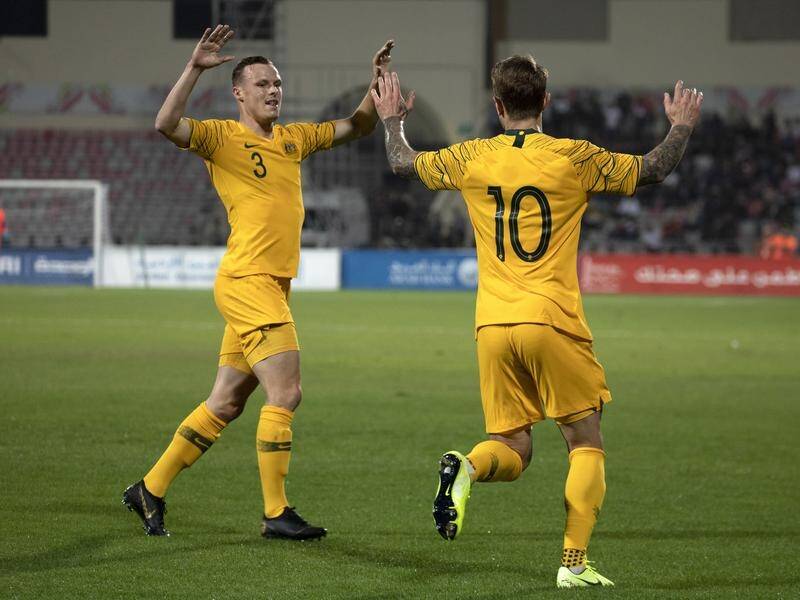 Socceroos striker Adam Taggart (R) celebrates his sixth international goal which saw off Jordan.