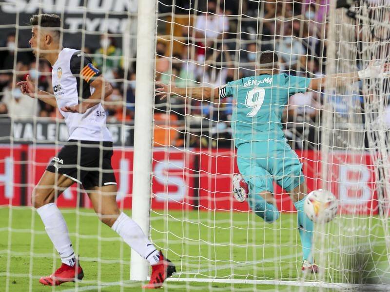 Real Madrid's Karim Benzema celebrates scoring the match-winning goal at Valencia.
