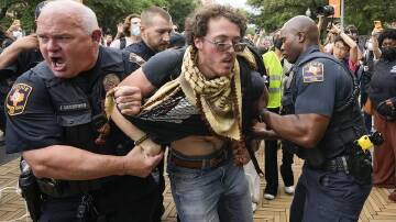 Hundreds of police clashed with protesters at the University of Texas at Austin. (AP PHOTO)