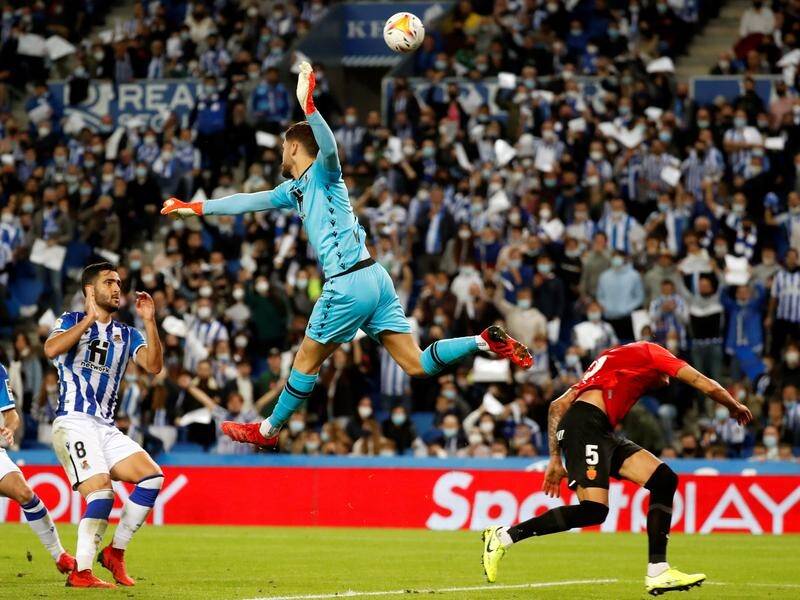 Real Sociedad goalkeeper Alex Remiro flaps at a bal against Real Mallorca in La Liga.