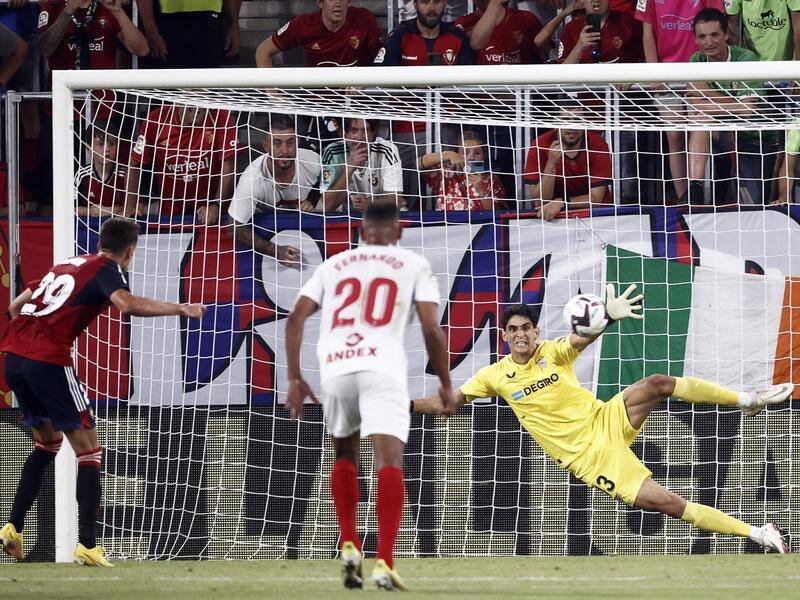 Osasuna's Aimar Oroz (l) scores from the spot to earn his team a 2-1 win over Sevilla in La Liga. (EPA PHOTO)