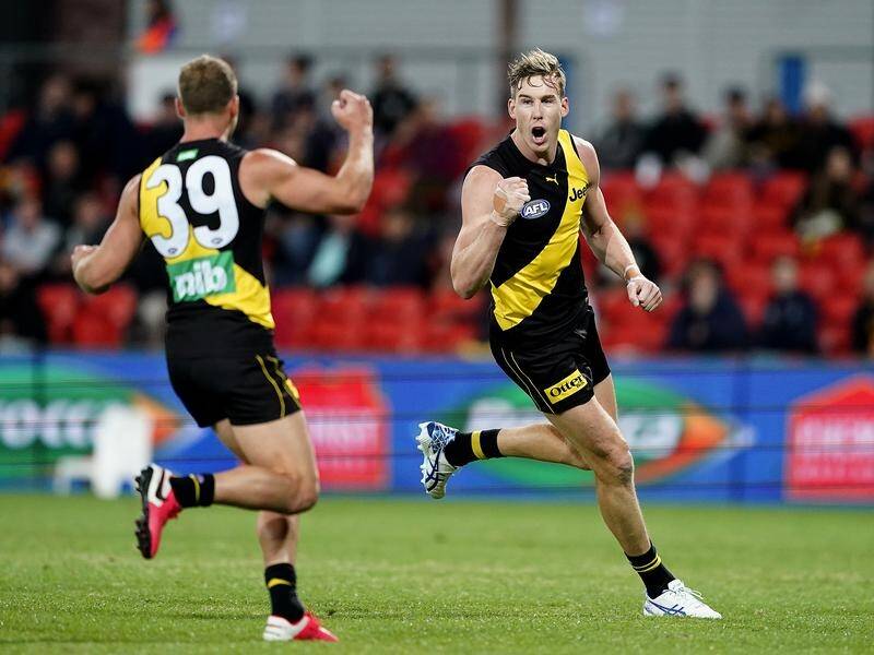 Tom Lynch (right) kicked three goals as the Tigers claimed a 41-point win against the Lions.