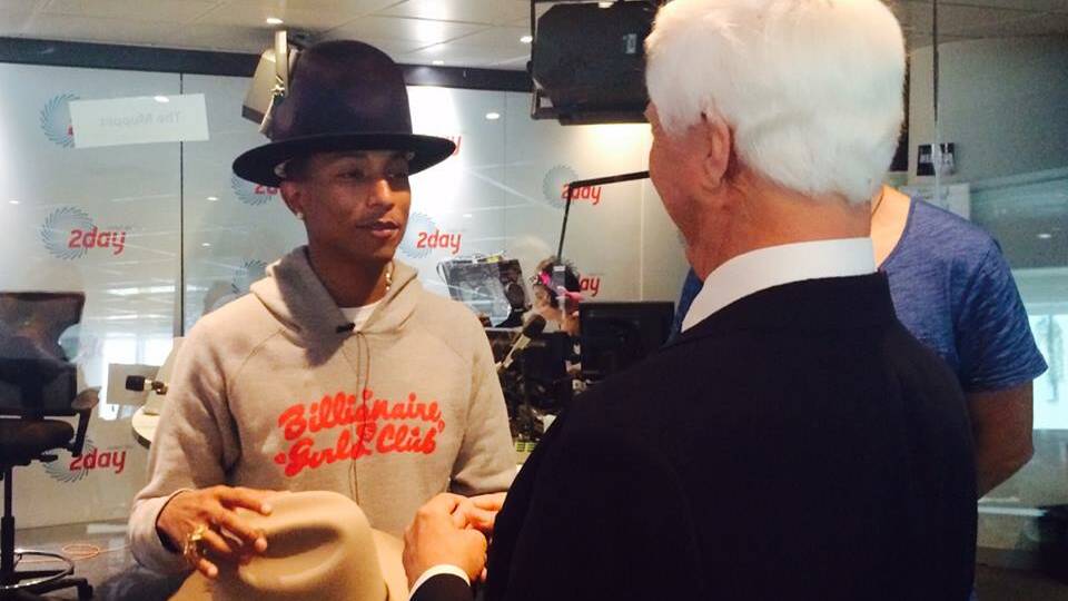  HANDOVER: Bob Katter hands over one of his Akubras to Pharrell Williams.