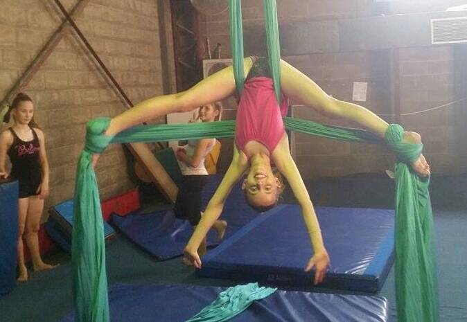 Talented performer Ryleigh Donald, 13, masters the silks at the Mount Isa School of Dance acrobatics intensive master class.