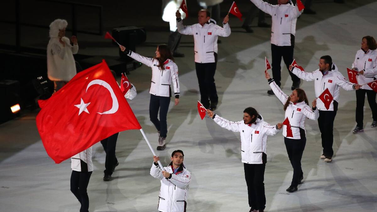 Figure skater Alper Ucar of the Turkey Olympic team carries his country's flag during the Opening Ceremony of the Sochi 2014 Winter Olympics. Picture: Getty