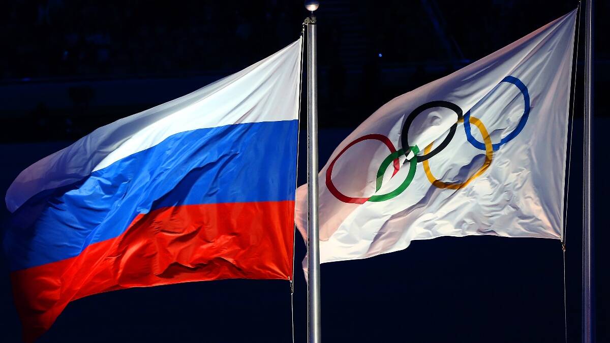 Russian and Olympic Flags fly side by side at the opening of the 2014 Winter Olympics in Sochi. Picture: Getty