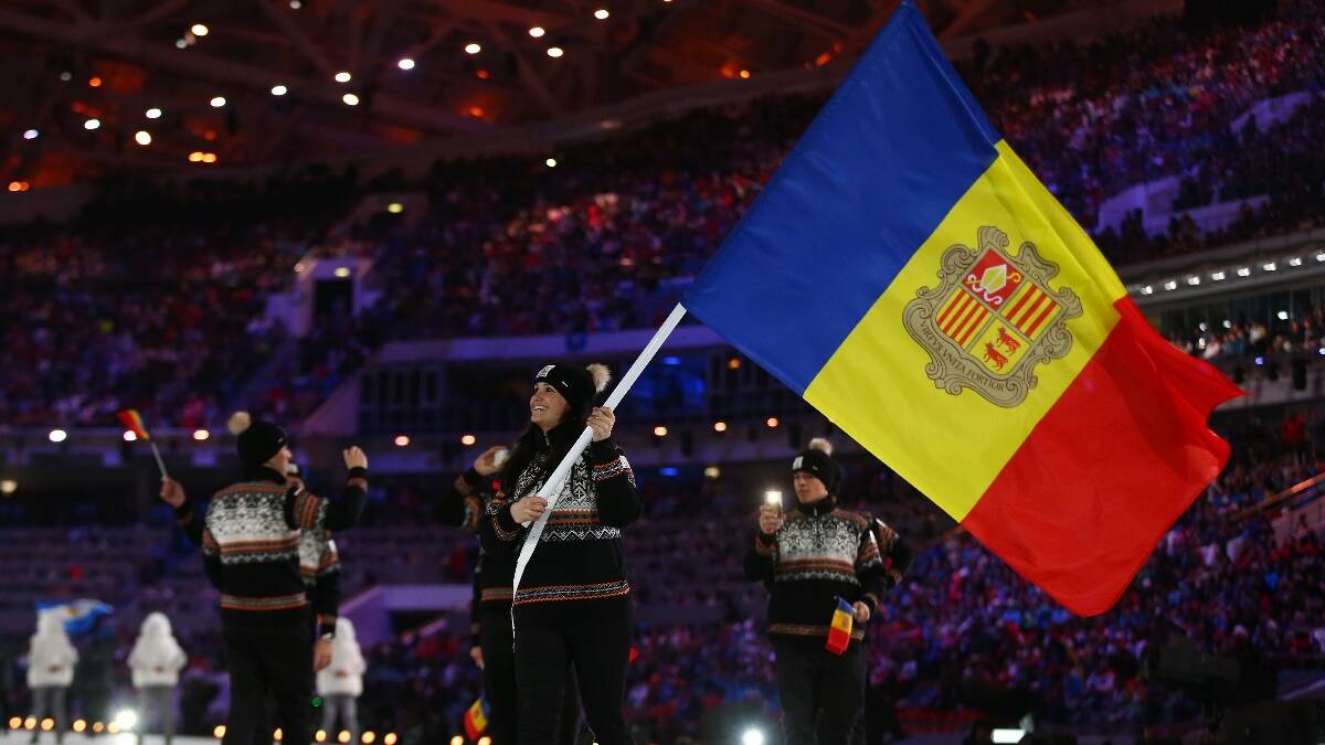 Skier Mireia Gutierrez of the Andorra Olympic team carries her country's flag during the Opening Ceremony of the Sochi 2014 Winter Olympics. Picture: Getty