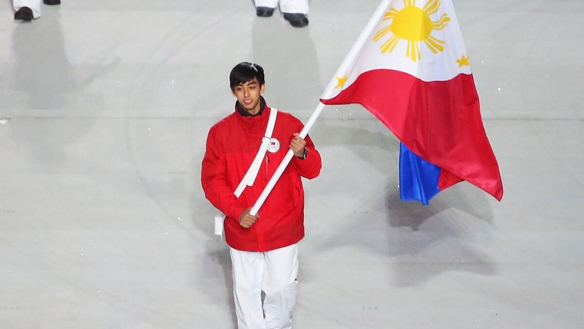 Figure skater Michael Christian Martinez of the Philippines Olympic team carries his country's flag during the Opening Ceremony of the Sochi 2014 Winter Olympics. Picture: Getty