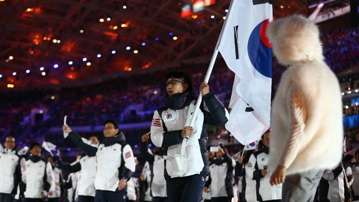 Speed skater Kyou Hyuk Lee of the South Korea Olympic team carries his country's flag during the Opening Ceremony. Picture: Getty