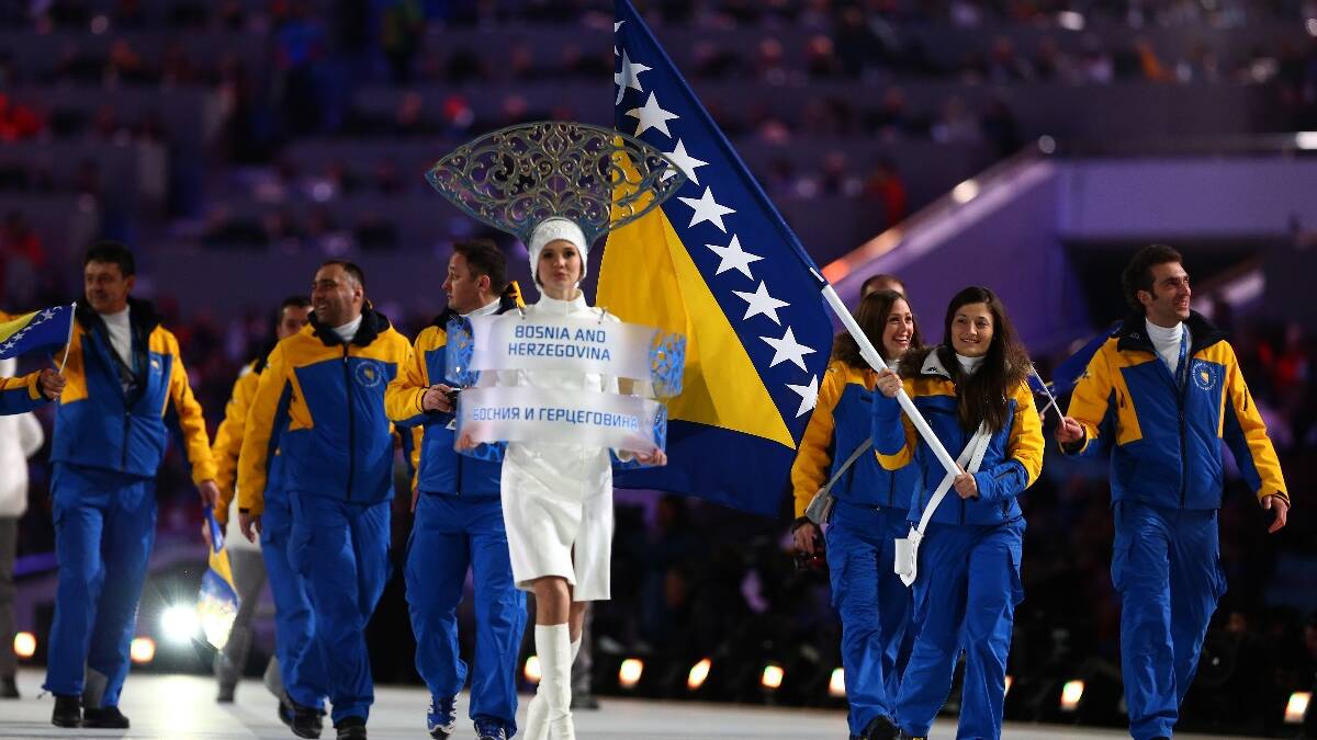 Skier Zana Novakovic of the Bosnia and Herzegovina Olympic team carries her country's flag during the Opening Ceremony of the Sochi 2014 Winter Olympics. Picture: Getty