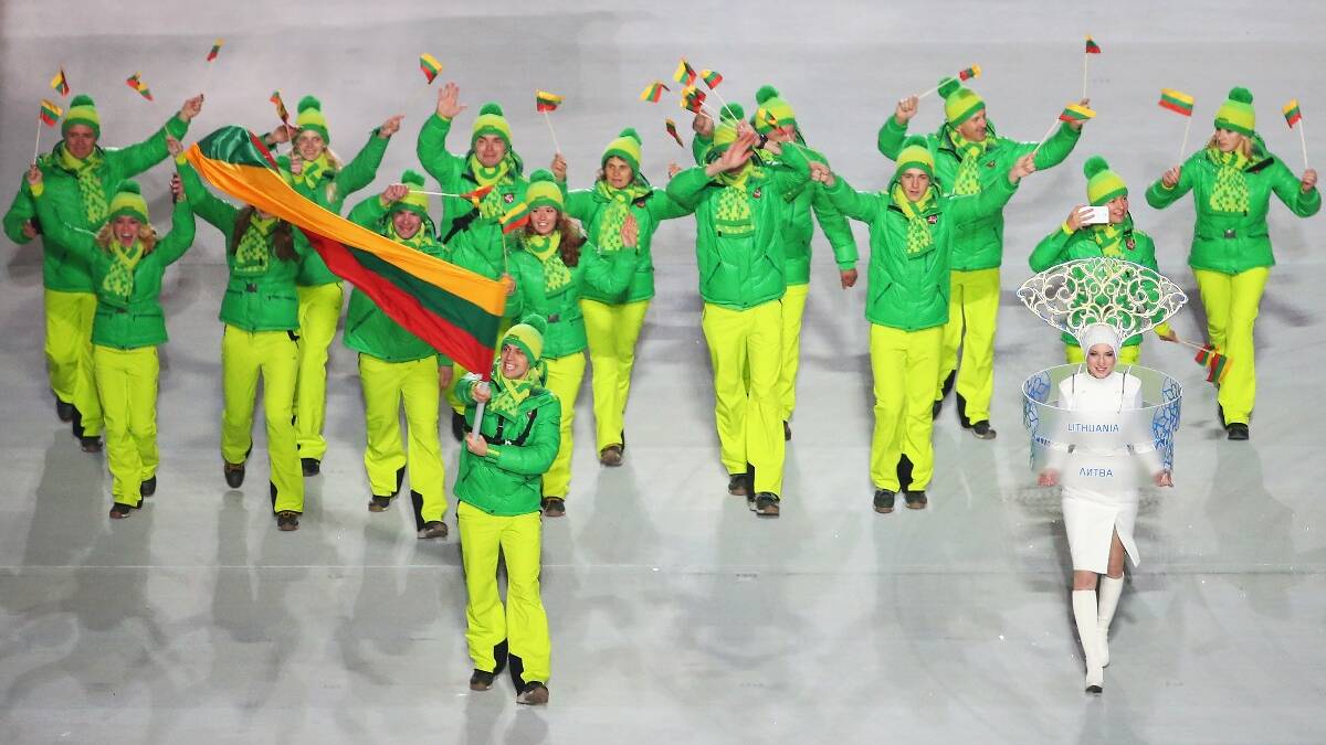 Figure skater Deividas Stagniunas of the Lithuania Olympic team carries his country's flag during the Opening Ceremony of the Sochi 2014 Winter Olympics. Picture: Getty