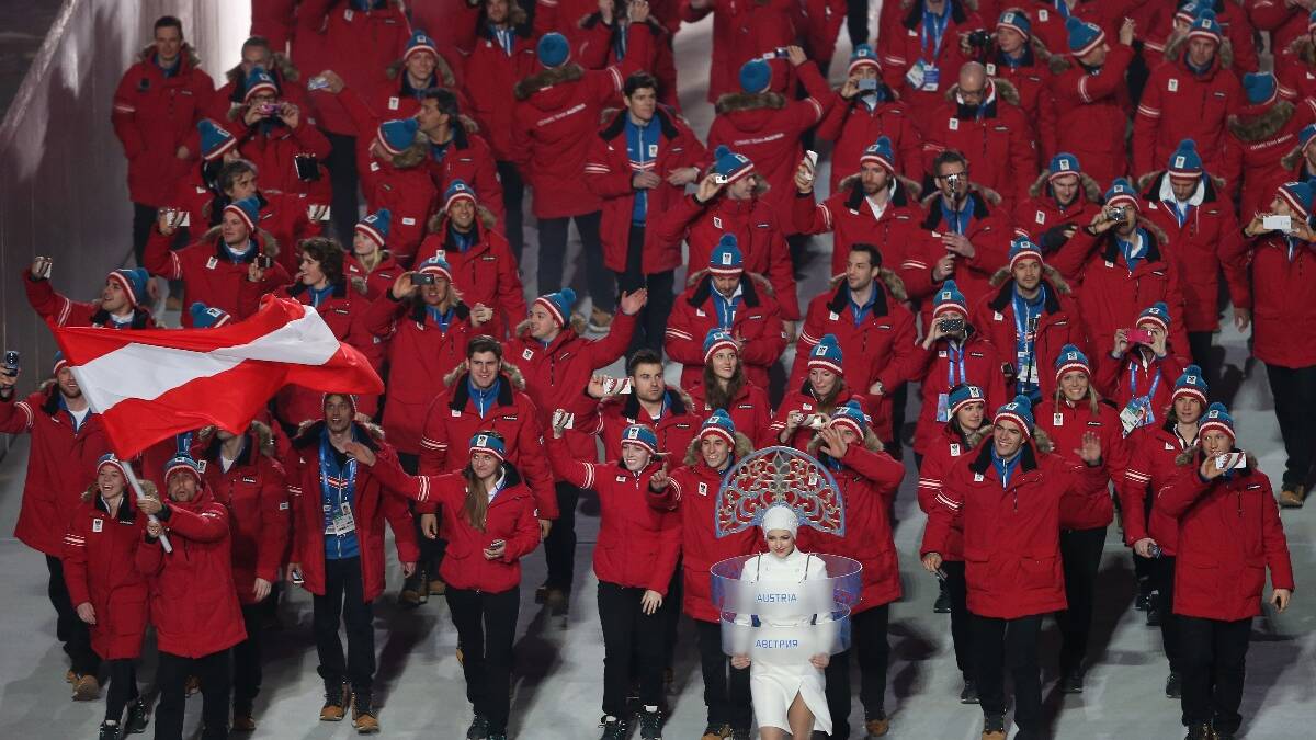 Nordic combined skier Mario Stecher of the Austria Olympic team carries his country's flag during the Opening Ceremony of the Sochi 2014 Winter Olympics. Picture: Getty