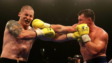 Paul Gallen (right) throws a right at Randall Rayment during their heavyweight bout during "Footy Show Fight Night" in Sydney in 2015. Picture: Getty Images