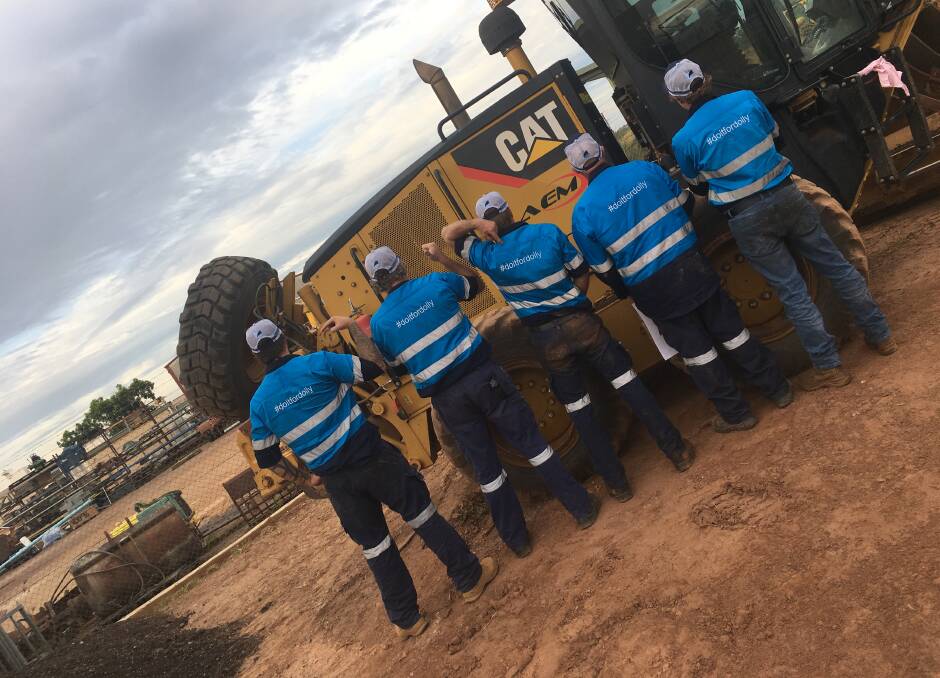 GOING BLUE: Arnhem Earthmoving and Mechanical staff don their blue hi vis for Do It For Dolly Day.
