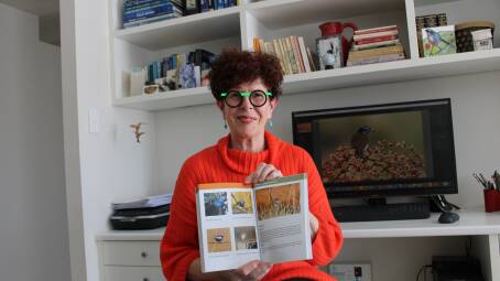 Ann Alcock with a copy of her and co-author Julie Ramsay's book titled Birds of Western Queensland. Picture Helen Walker