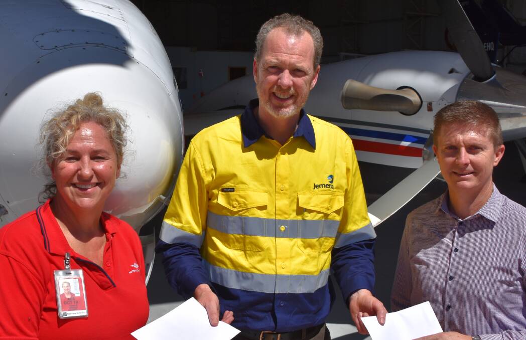 GIVING BACK: Timna Wright from RFDS, Jemena's top dog Paul Adams and Lifeflight's Brian Guthrie with the two $12,500 cheques. 