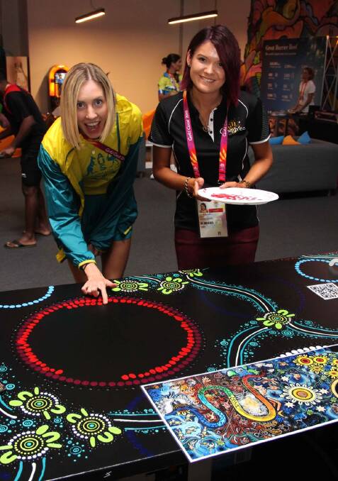 LOCAL STAR: Kalkadoon artist Chern’ee Sutton (right) began work on a 12 metre painting in the athletes village this week. Picture: supplied. 