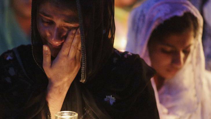 Mourners cry during a candlelight vigil at the Sikh temple in Brookfield, Wisconsin.