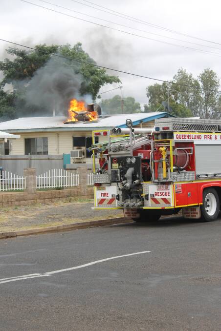 HOUSE FIRE: The blaze at 3 Campbell Street spilled out onto the roof as fire services tried to contain it yesterday. -Picture:HAILEY RENAULT/7355