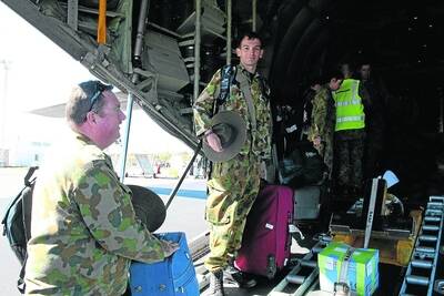 LOADING UP: Corporal (AAFC) David Pringle and Cadet Matthew Downes load baggage onto the back of the Hercules.