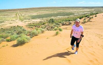 DUNE TUNE: Jenna traverses one of the 1100 sand dunes she encountered in her walk across the desert.