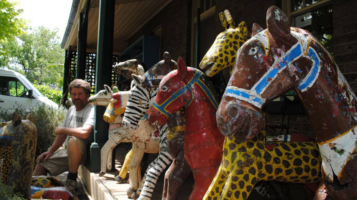 Kev Danzey from Black Sheep Antiques in Bowral with his new shipment of old carousel horses from Java. Picture: Eliza Winkler