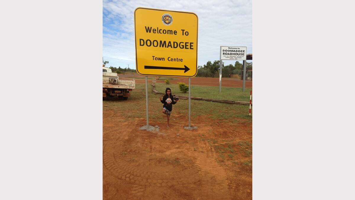 BLOCKED OFF: Doomadgee resident Kalan Karkadoo, 9, with one of the town's new signs.