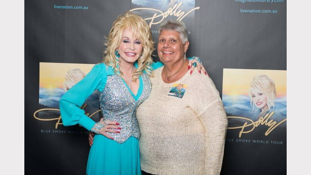 THRILLED TO BITS: Maureen Conlan poses with singer Dolly Parton when she met her in Brisbane last week.