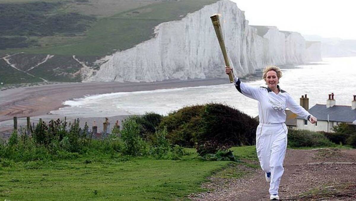 Tradition ... the Olympic Torch travels past the Seven Sisters cliffs in East Sussex. Photo: LOCOG