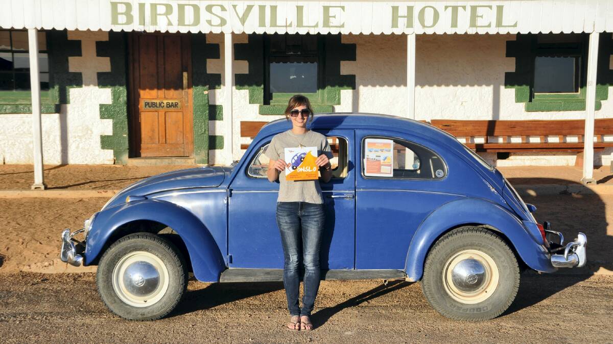 ONSLO OUTBACK TALES: Author Kelly Theobald with her book Onslo outside the Birdsville Hotel.