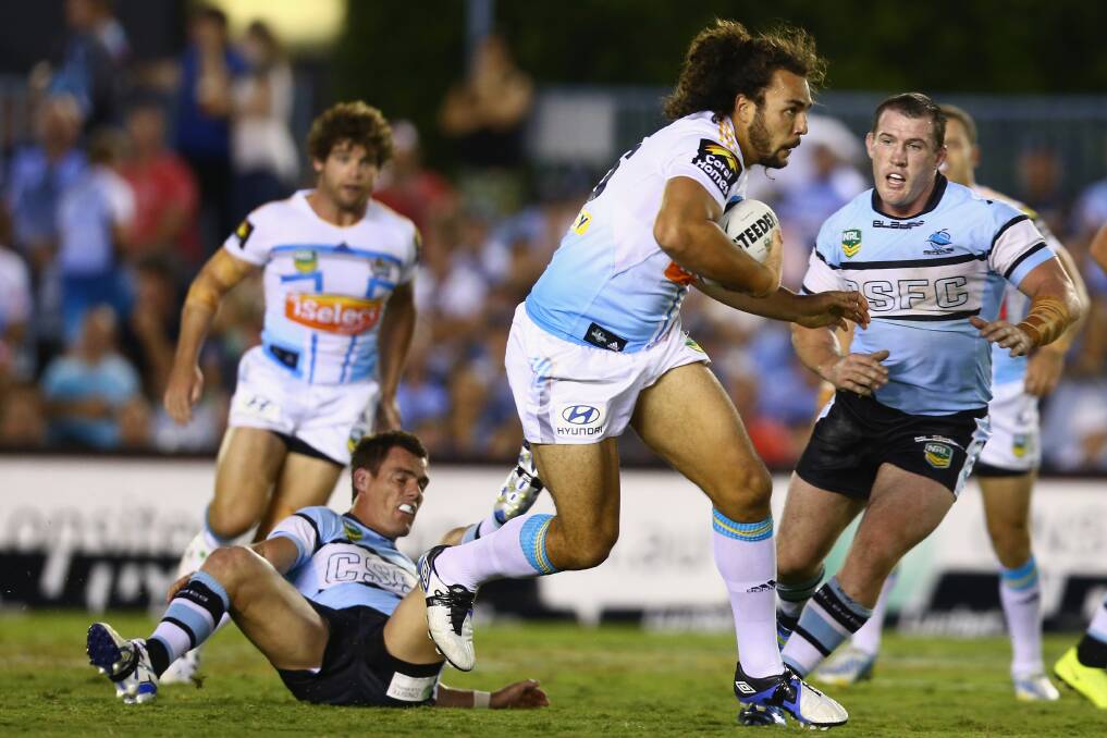 Ryan James of the Titans makes a break during the round one NRL match between the Cronulla Sharks and the Gold Coast Titans. Photo by Mark Kolbe/Getty Images