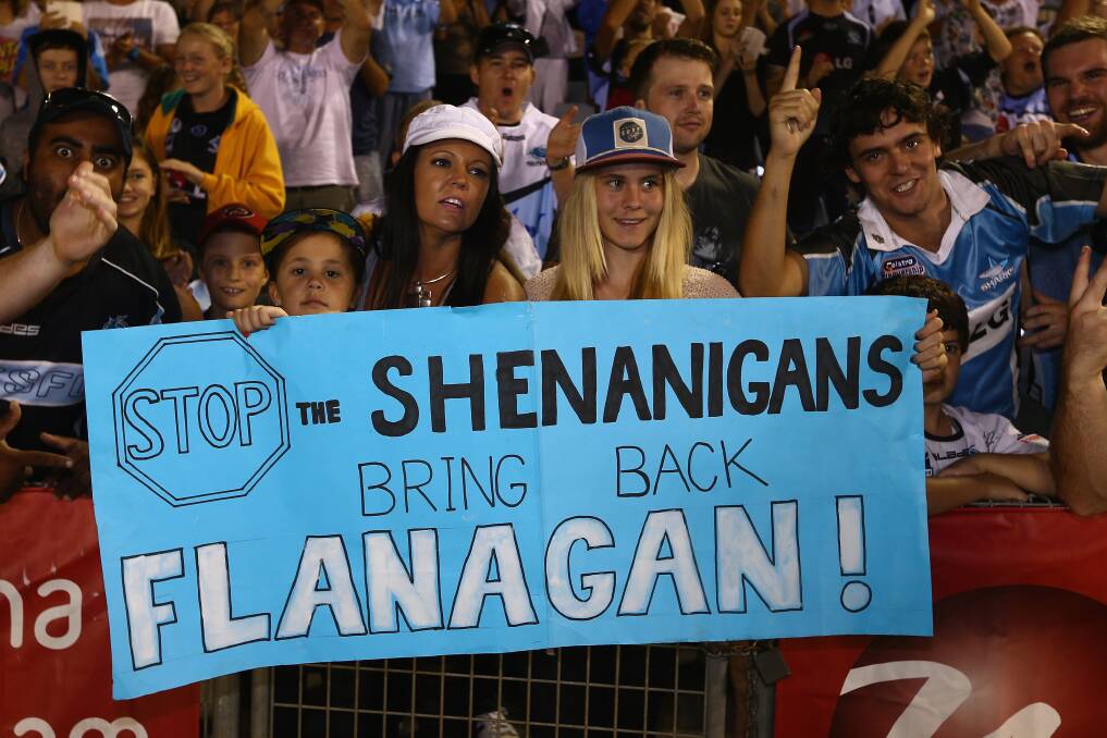 Sharks supporters hold up a sign in support of the Sharks coach Shane Flannagan. Photo by Mark Kolbe/Getty Images