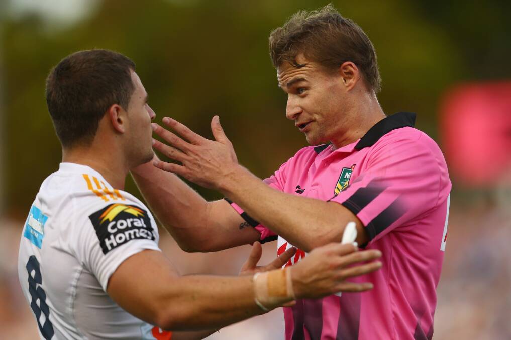 Referee Phil Haines speaks to Aidan Sezer of the Titans. Photo by Mark Kolbe/Getty Images