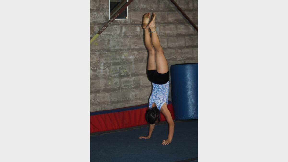 UPSIDE DOWN: Isabella James Corsaro, 11, does a handstand.